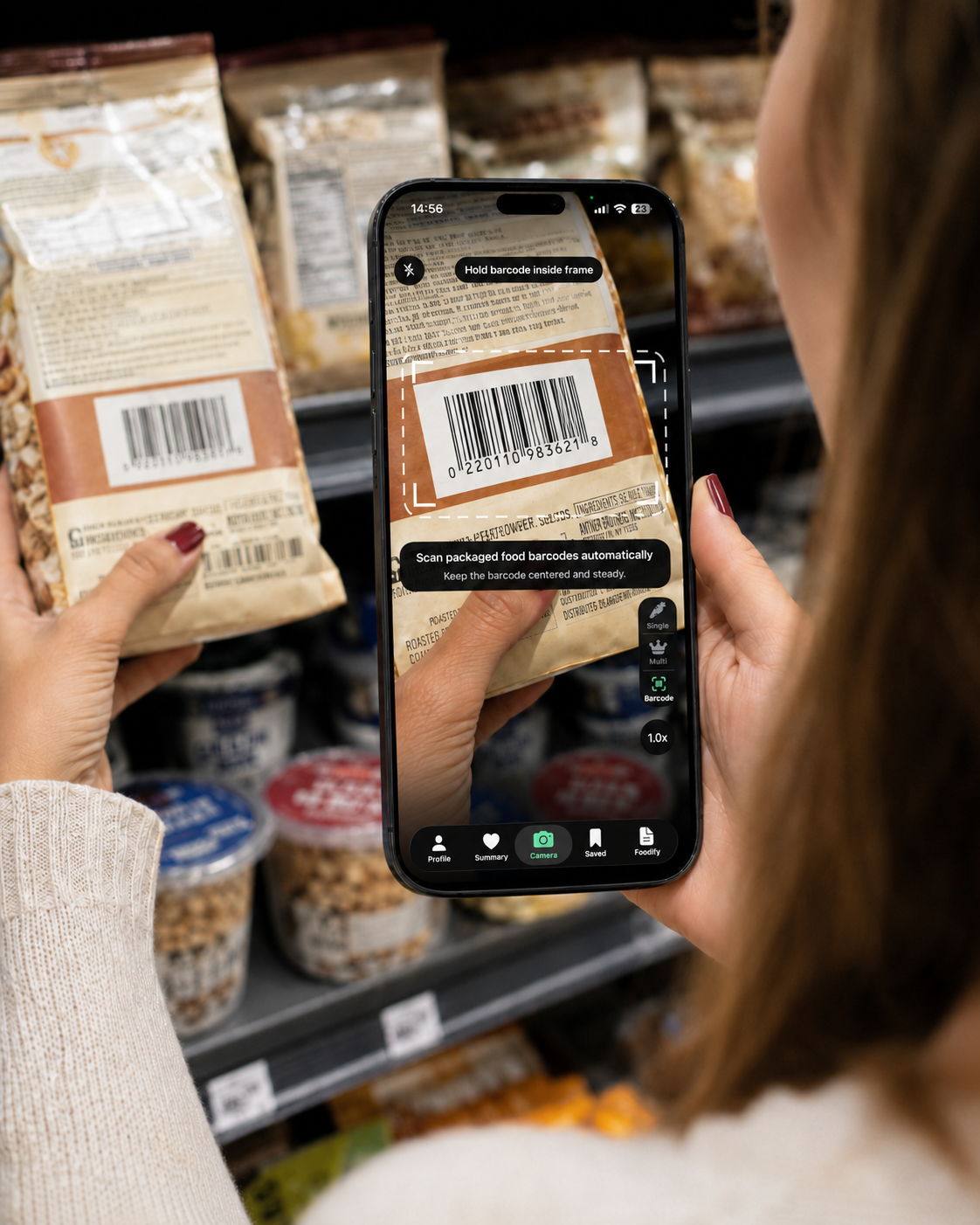 A person scanning a packaged food barcode with Foodify at a grocery store